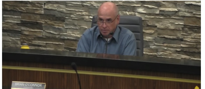 A council member seated at the dais during the vote